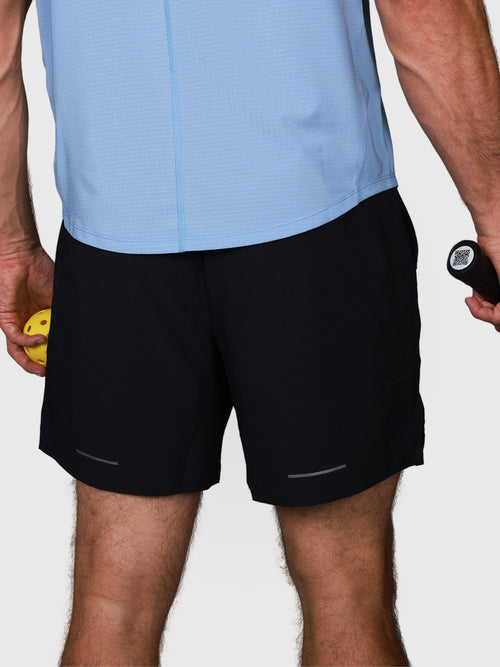 rear view of man wearing Black Base Line Short by MUEV designed for pickleball and padel apparel