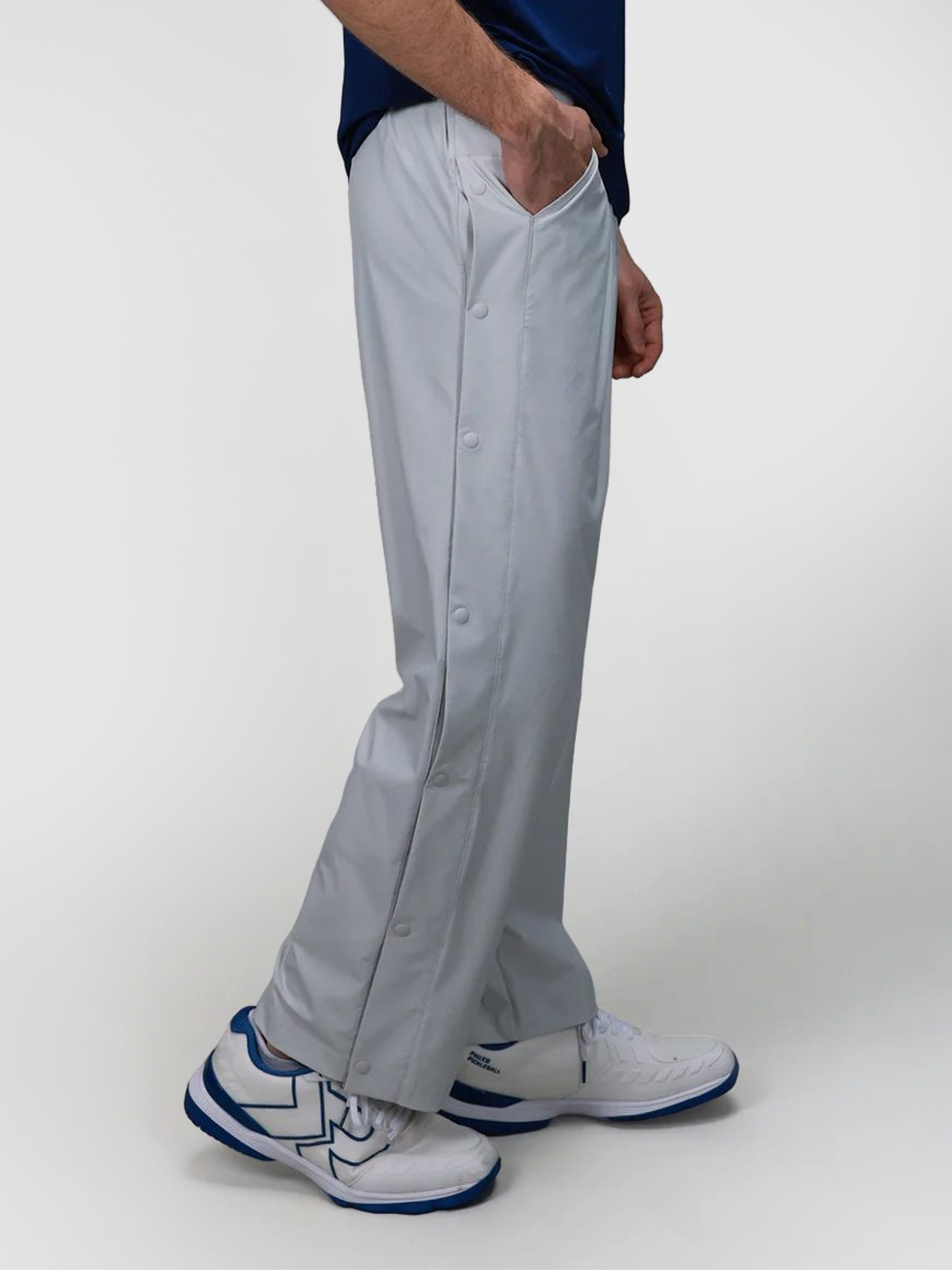 Side view of gray J Sas Tear Away Pant by MUEV, designed for padel and pickleball apparel with snap button details