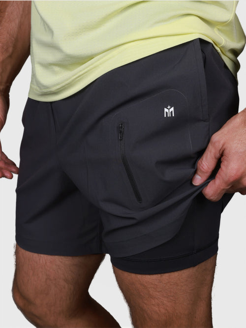 Black Apex Pro Compression Short by MUEV featuring zippered pocket and layered design for padel and pickleball clothing
