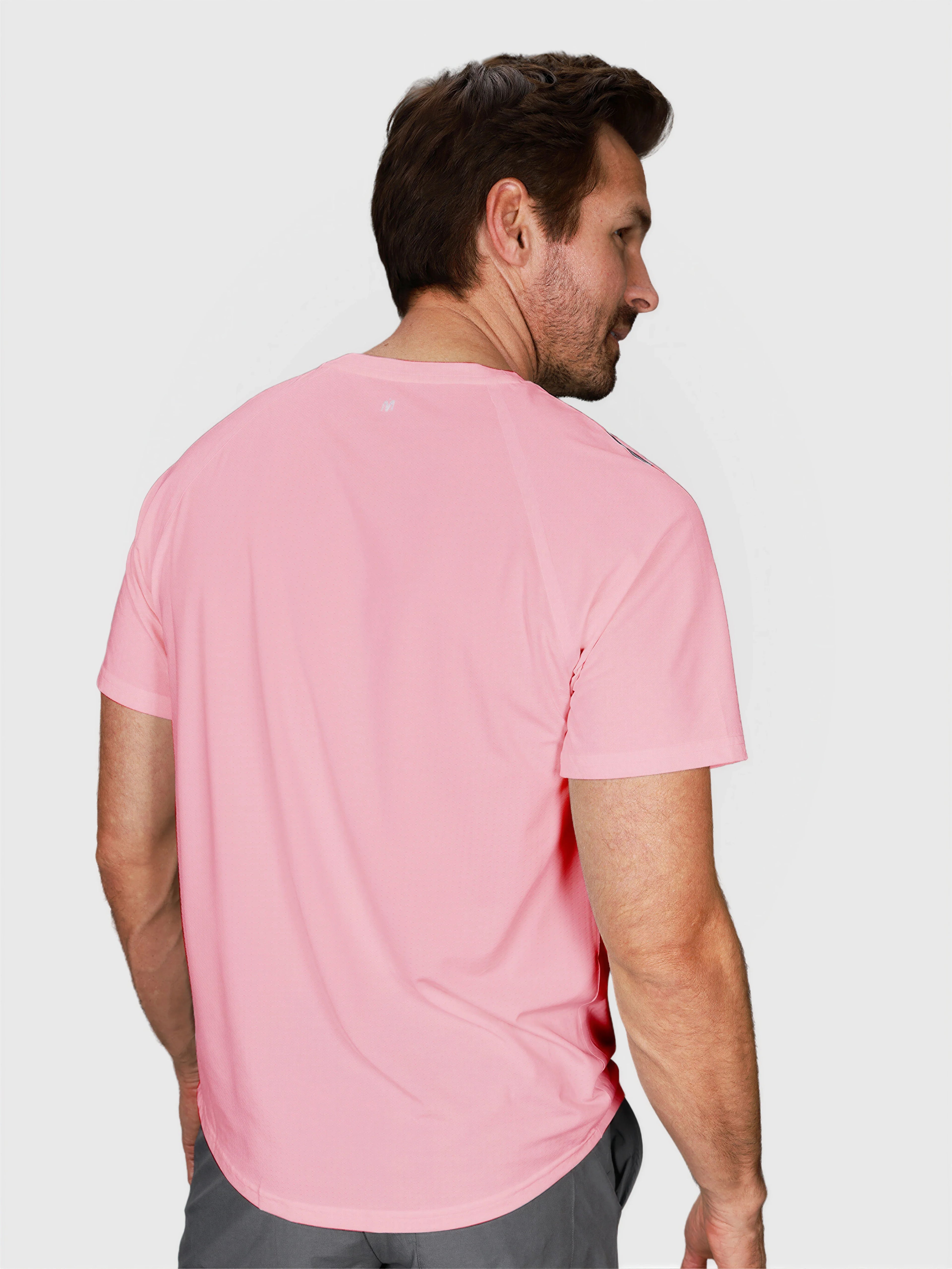 Man modeling coral Dink Performance Tee by MUEV shown from rear for padel and pickleball clothing