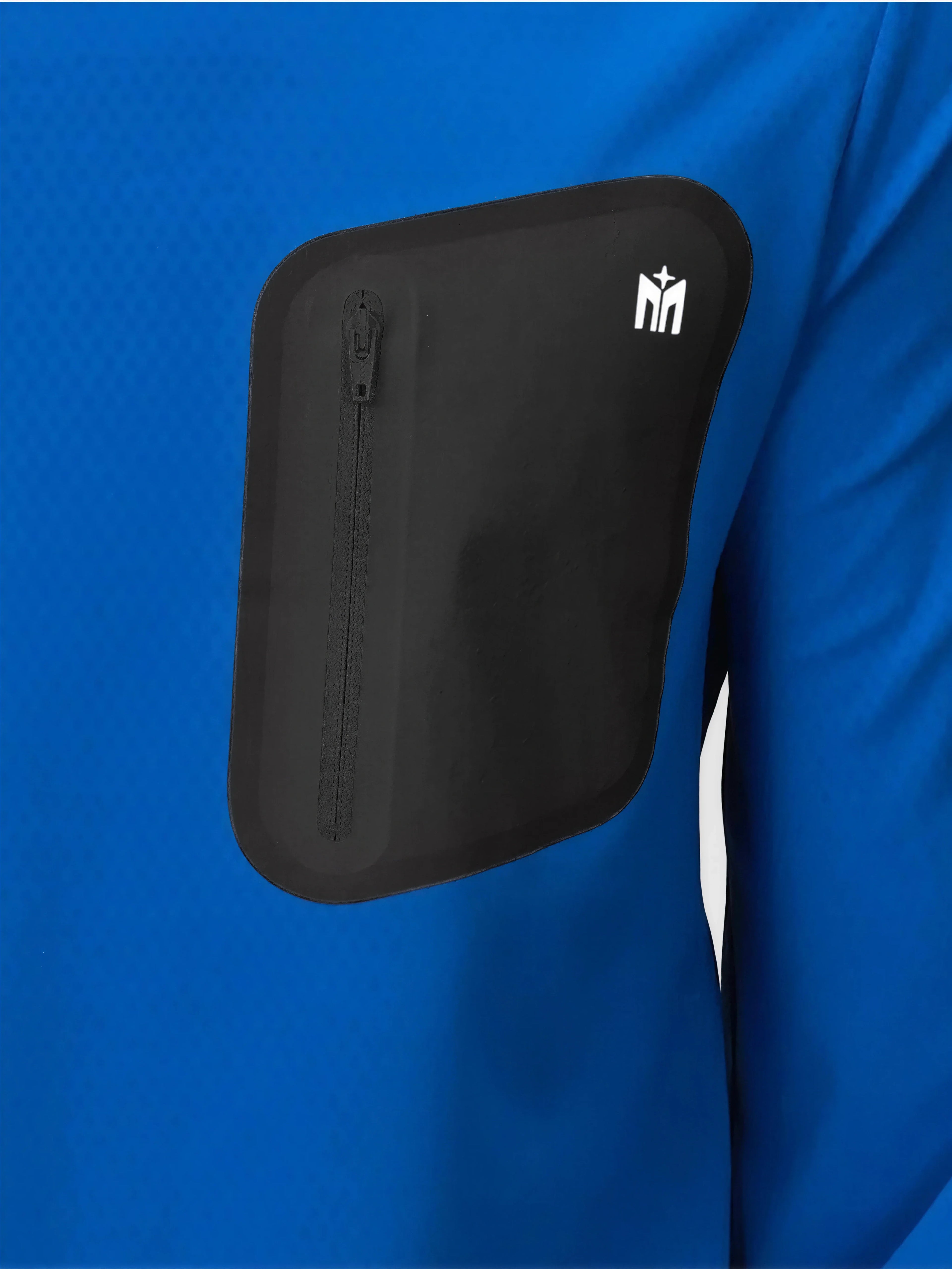 Detail of black zippered chest pocket on royal blue Echelon Long Sleeve Shirt by MUEV for pickleball and padel apparel