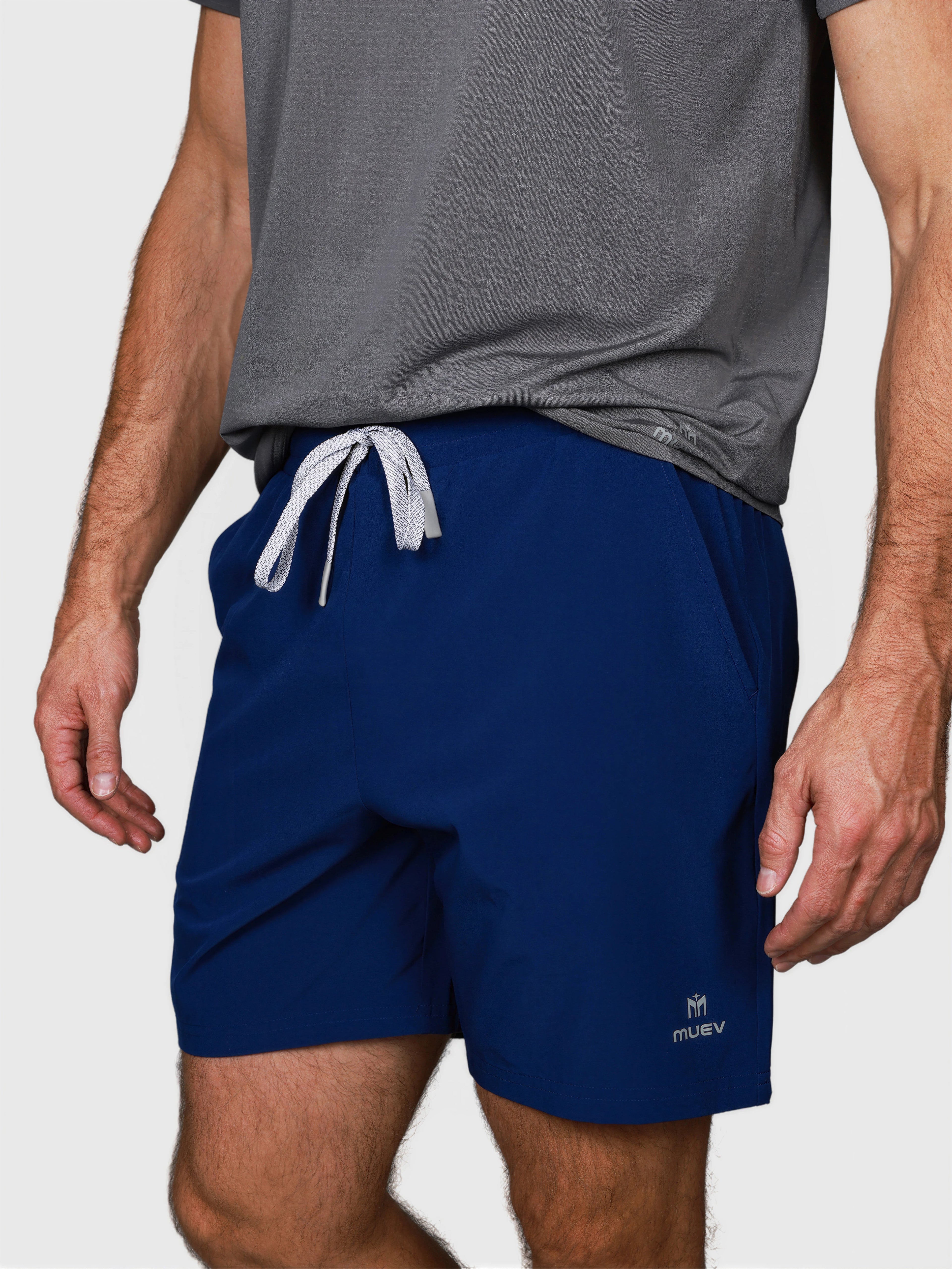 man wearing navy Kick It Short by MUEV with gray drawstring waist designed for padel and pickleball apparel