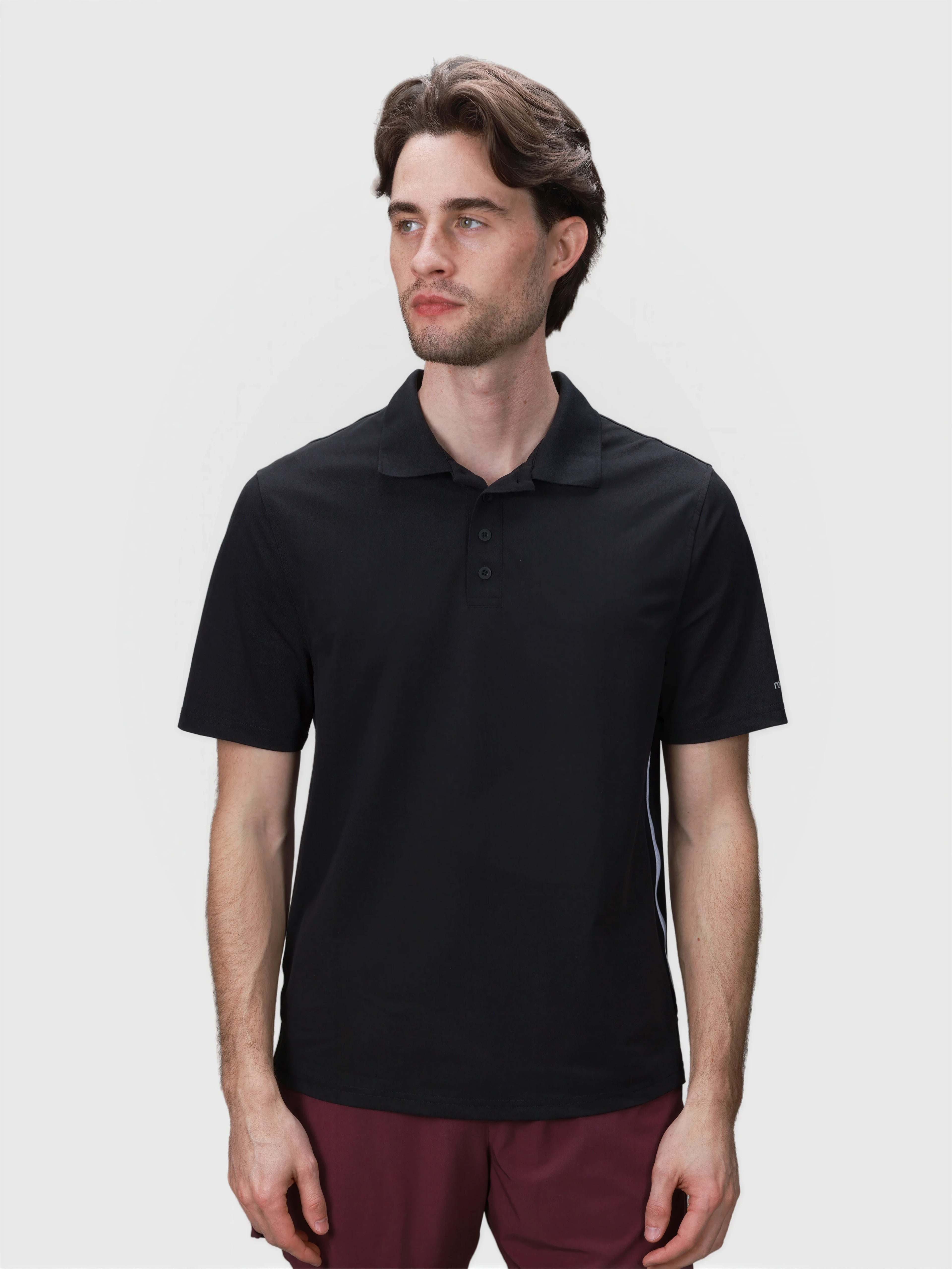 Man wearing black Tip Polo by MUEV designed for padel apparel with classic collar and button placket details
